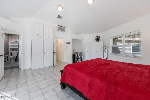 a spacious bedroom with a bed and a window