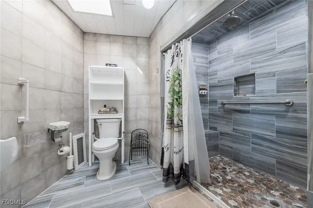 a bathroom with a toilet and shower
