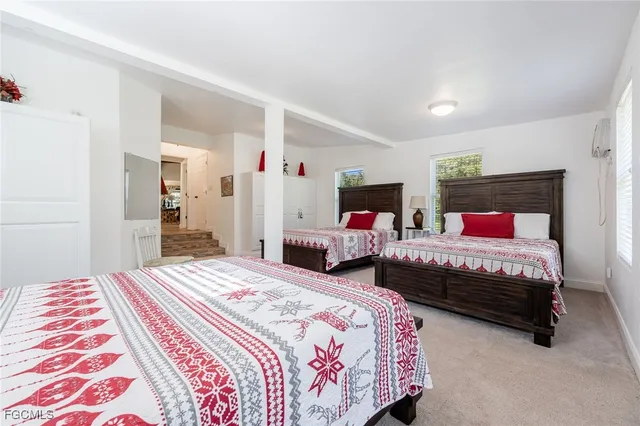 a bedroom with two beds and a chandelier