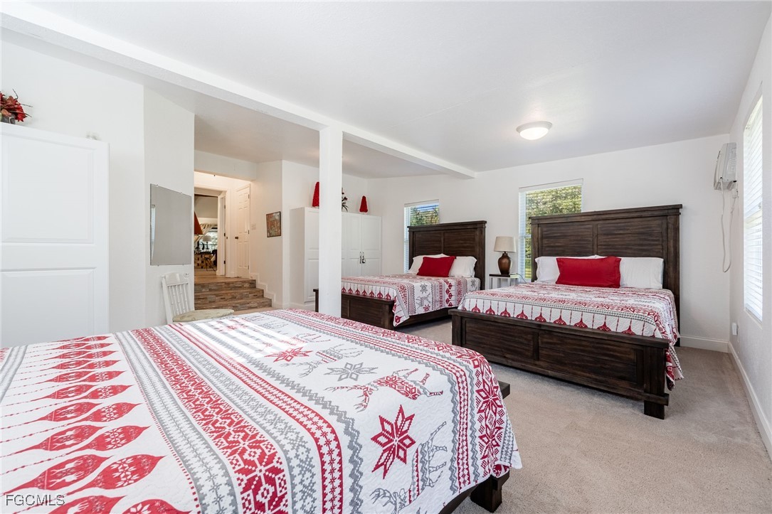 1400 Catamount Road LaBelle, FL 33935 - Photo 28 of 50 a bedroom with two beds and a chandelier