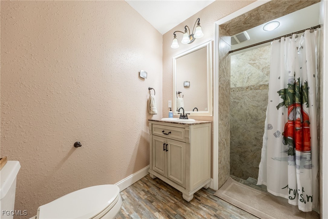 1400 Catamount Road LaBelle, FL 33935 - Photo 29 of 50 a bathroom with a sink a toilet and shower