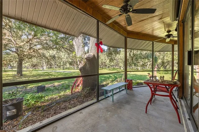 a view of a porch with furniture and a yard