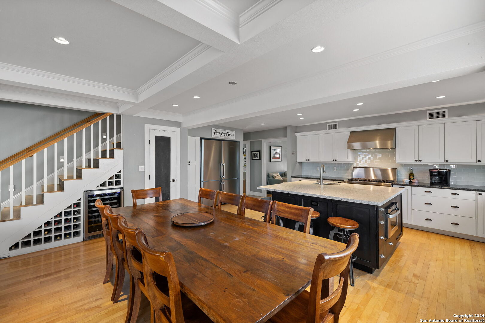 a dining hall with stainless steel appliances a dining table and chairs with wooden floor