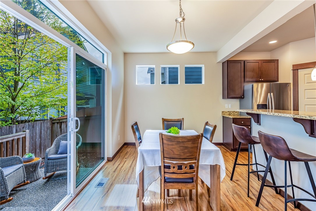 413 203rd Place Southeast Bothell, WA 98012 - Photo 14 of 38 a view of a dining room with furniture window and wooden floor