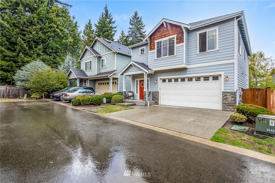 413 203rd Place Southeast Bothell, WA 98012 - Photo 38 of 38 a front view of a house with a yard and garage
