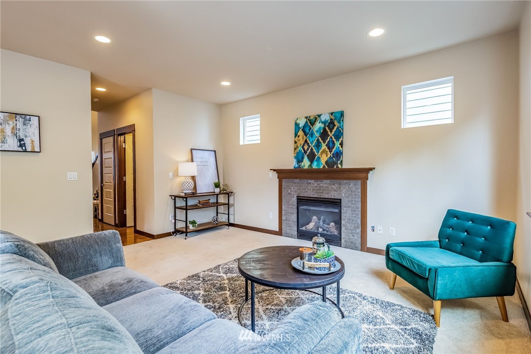 413 203rd Place Southeast Bothell, WA 98012 - Photo 10 of 38 a living room with furniture and a fireplace