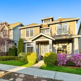 a front view of a house with a garden and plants
