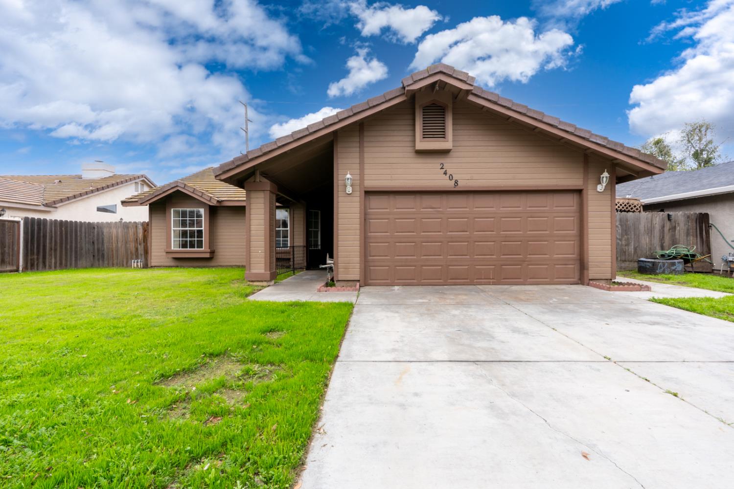 a front view of house with yard and green space