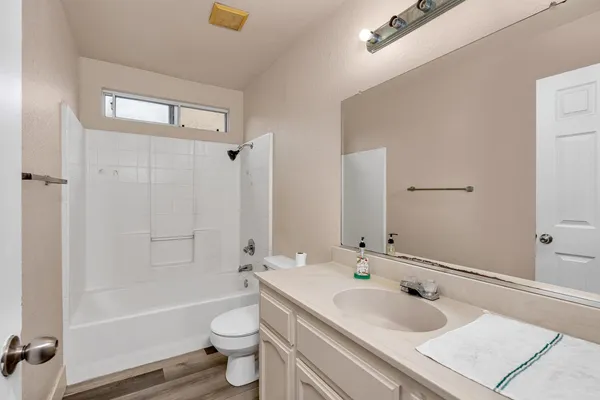 a view of a ceiling fan and wooden floor