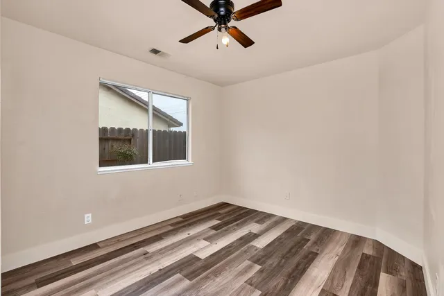 a view of a room with wooden floor and stairs