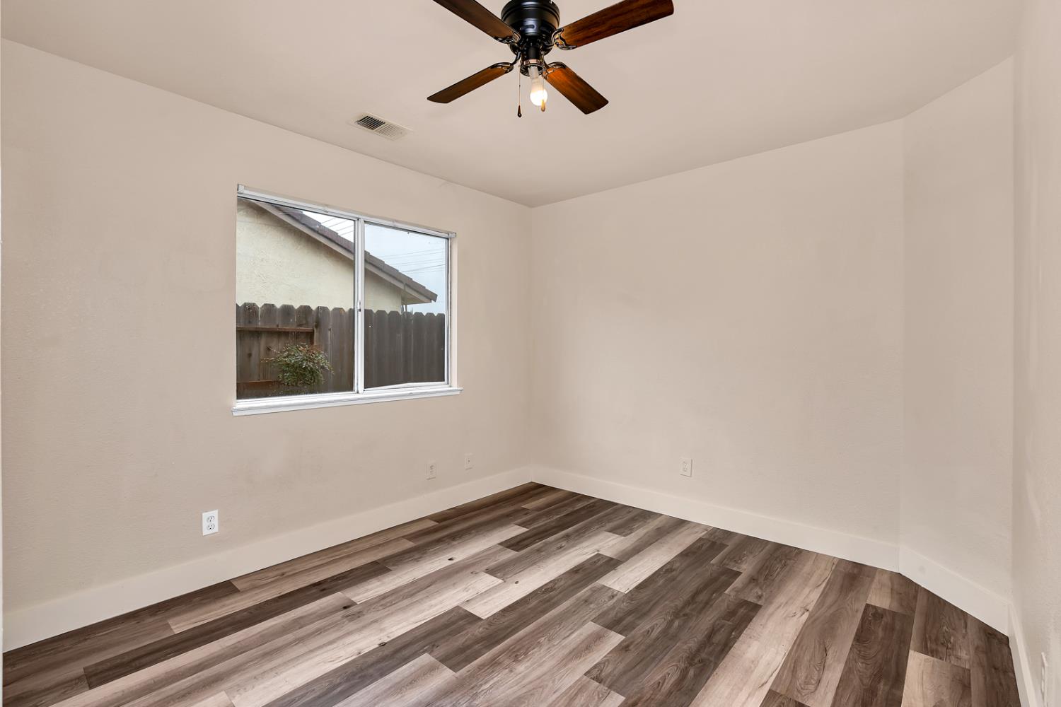 2408 Beatrice Lane Modesto, CA 95355 - Photo 20 of 36 a view of a ceiling fan and wooden floor