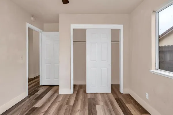 a view of empty room with wooden floor