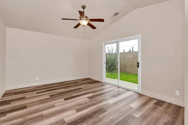 a view of an empty room and wooden floor