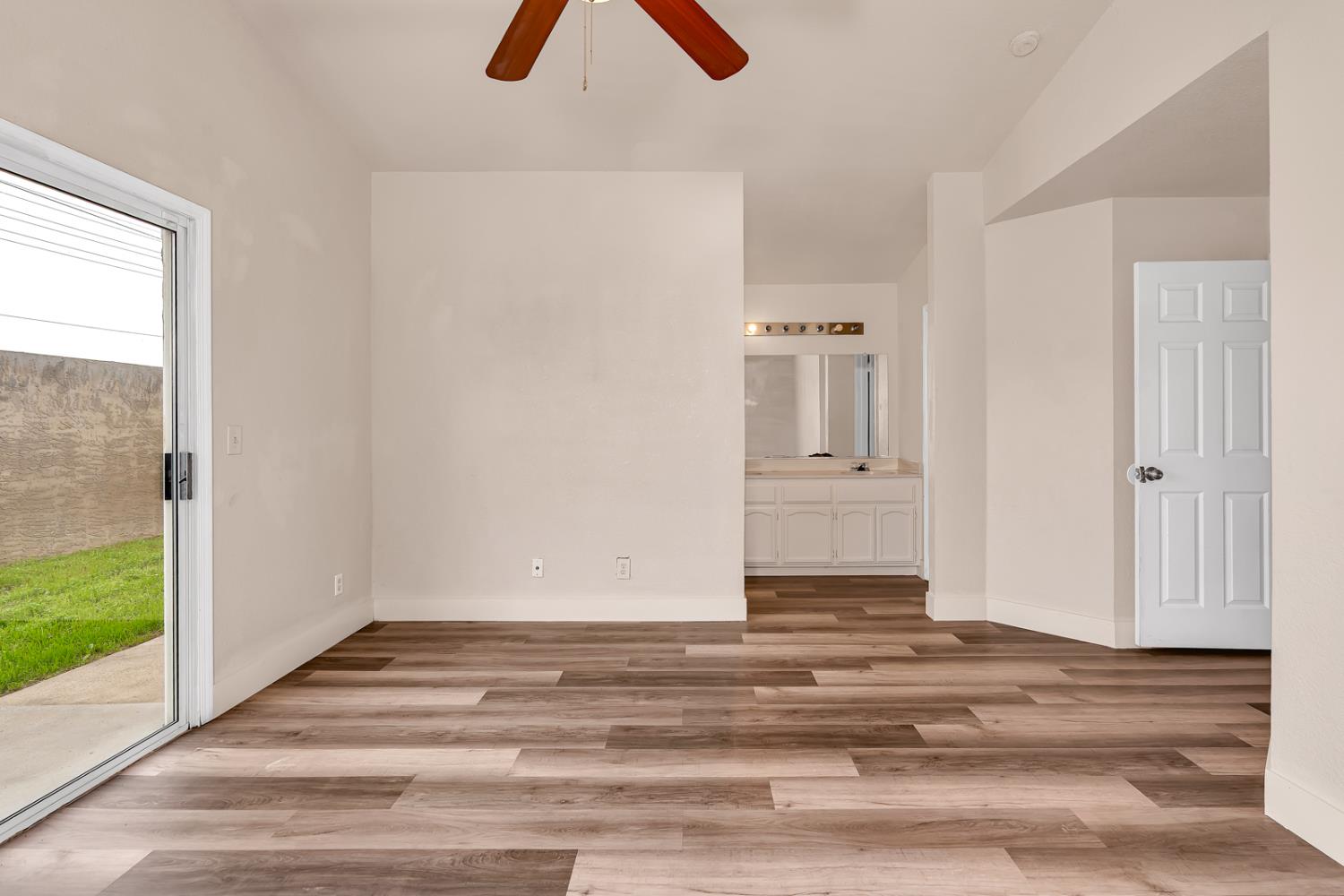 2408 Beatrice Lane Modesto, CA 95355 - Photo 24 of 36 a view of a livingroom with wooden floor and a ceiling fan