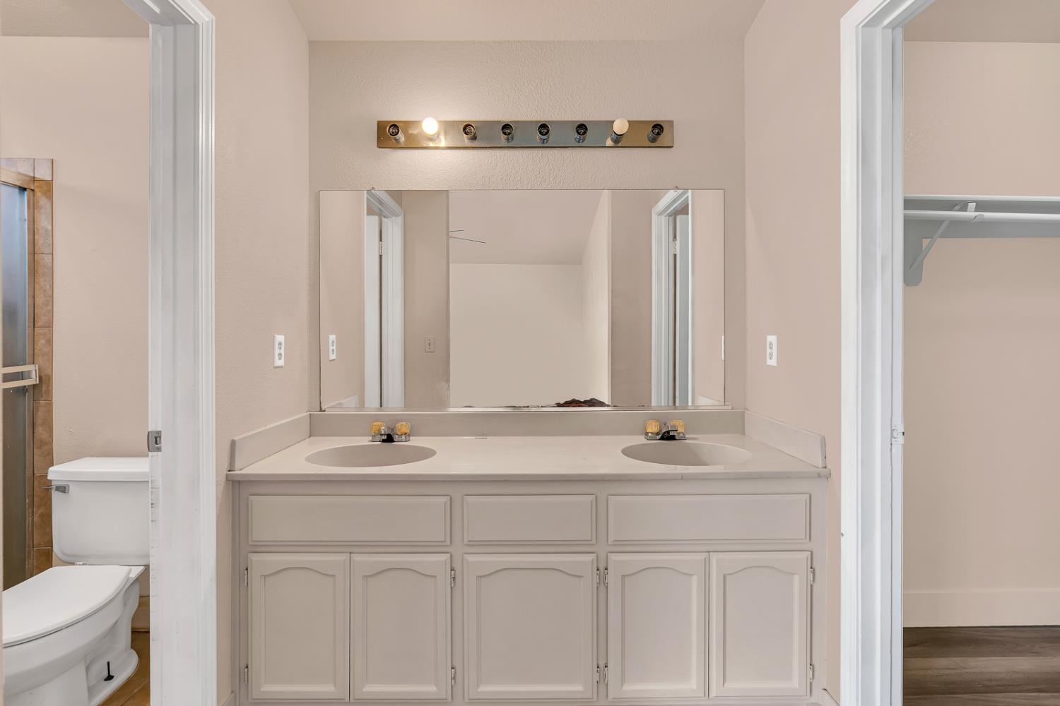2408 Beatrice Lane Modesto, CA 95355 - Photo 25 of 36 a bathroom with a sink vanity toilet and mirror