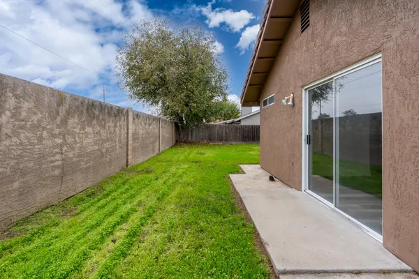 a view of a patio with a yard