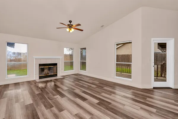 a view of a livingroom with a fireplace and window