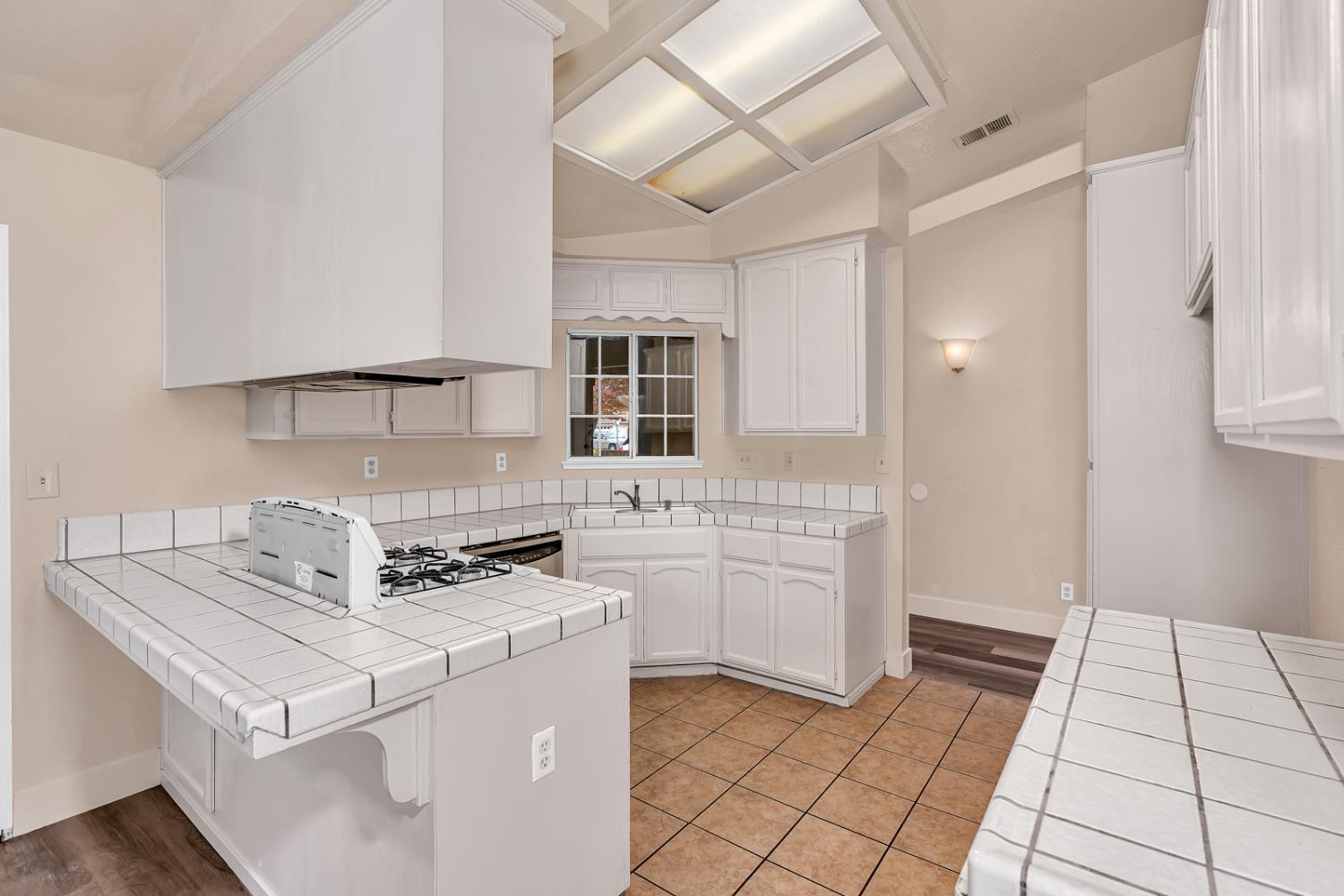 2408 Beatrice Lane Modesto, CA 95355 - Photo 7 of 36 a kitchen with cabinets and white appliances
