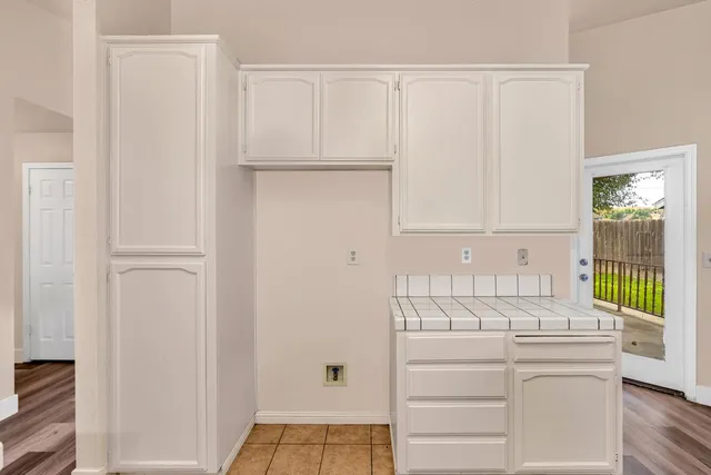 a view of a kitchen with white cabinets