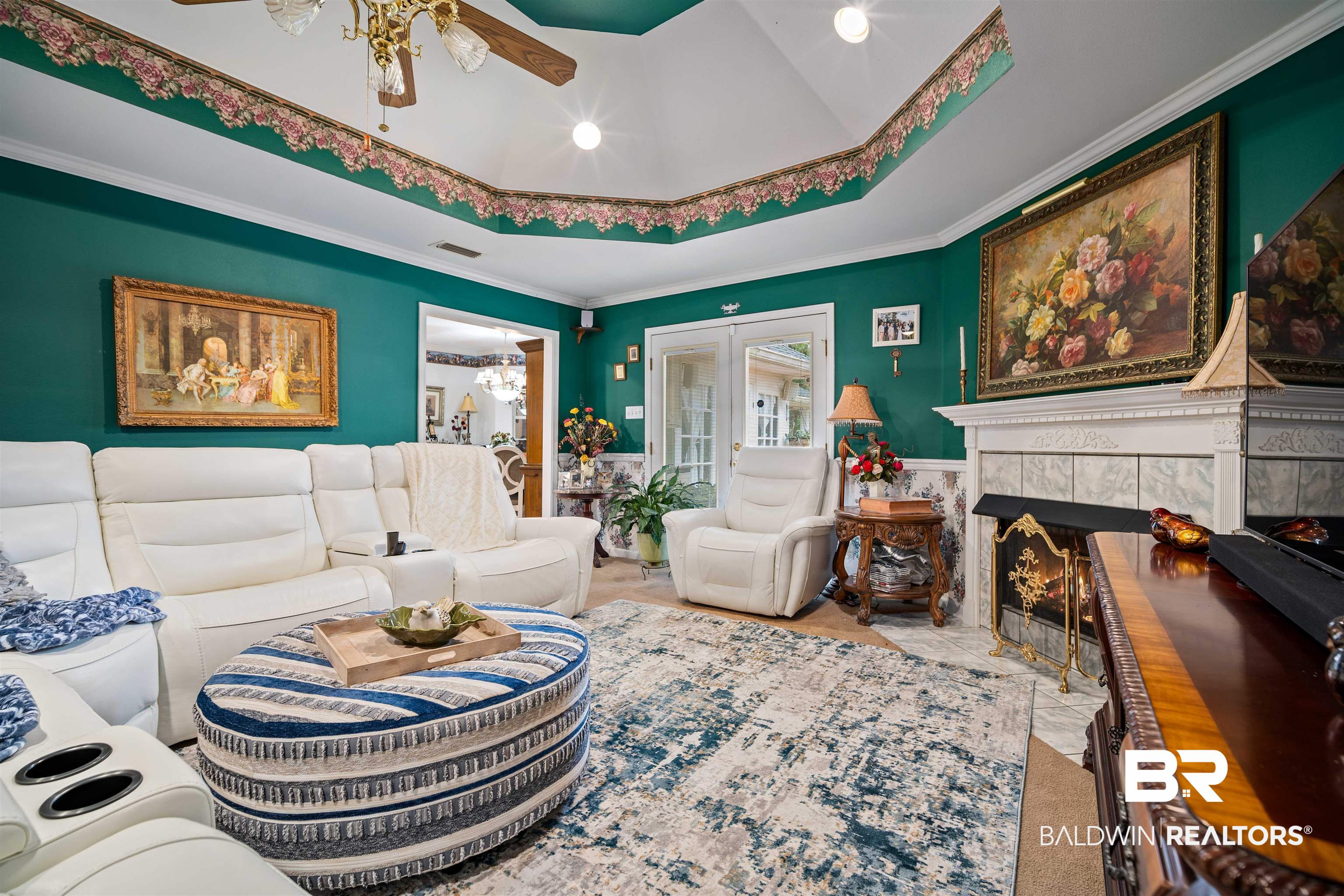 1744 Aden Road Mobile, AL 36695 - Photo 4 of 35 Living room featuring a tile fireplace, a raised ceiling, ceiling fan, and ornamental molding