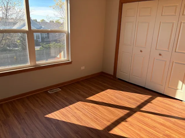 a view of a room with wooden floor and a window