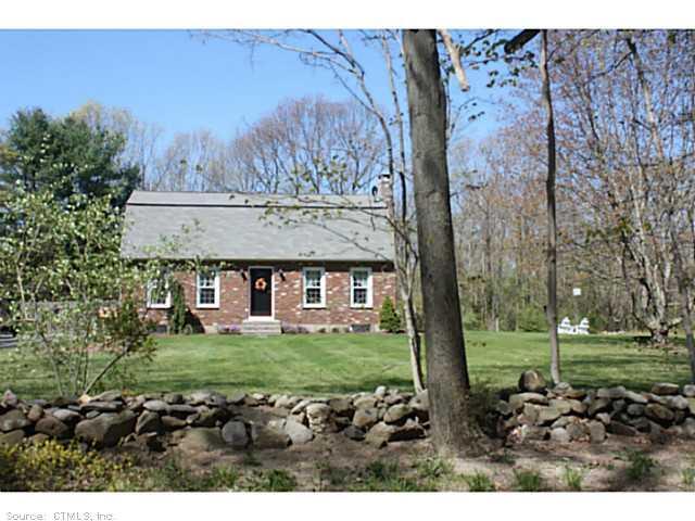 Exterior Front. Set back from the road with stone walls