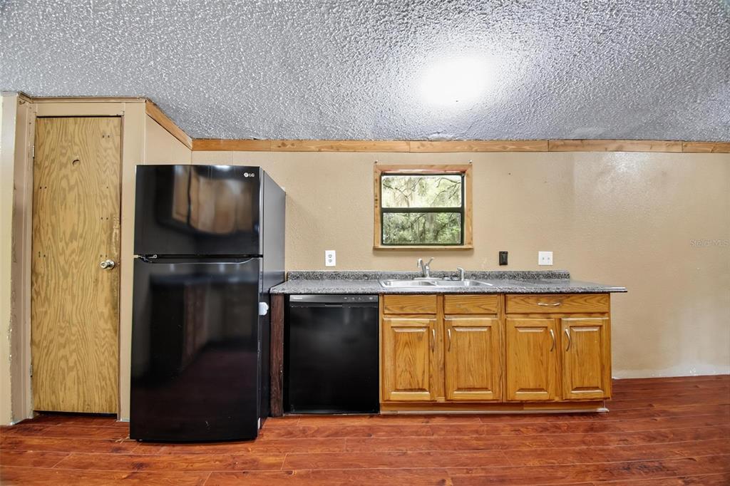 156 Kingfish Road Pomona Park, FL 32181 - Photo 28 of 55 a kitchen with a sink a refrigerator and window