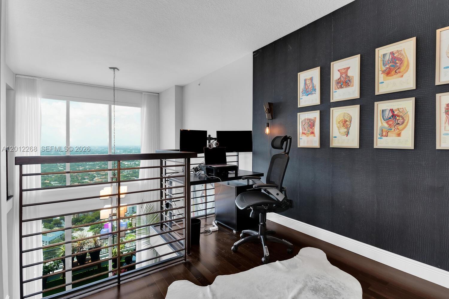 60 Southwest 13th Street, Unit 4005 Miami, FL 33130 - Photo 14 of 27 a view of a workspace with furniture and a window