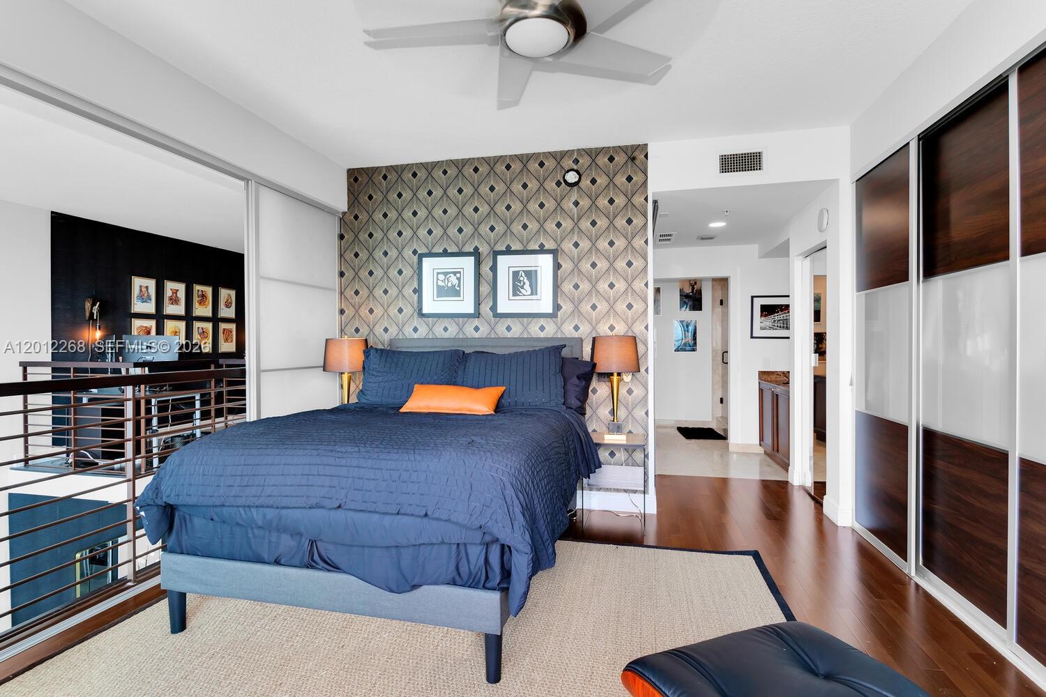 60 Southwest 13th Street, Unit 4005 Miami, FL 33130 - Photo 17 of 27 a bedroom with a bed and wooden floor