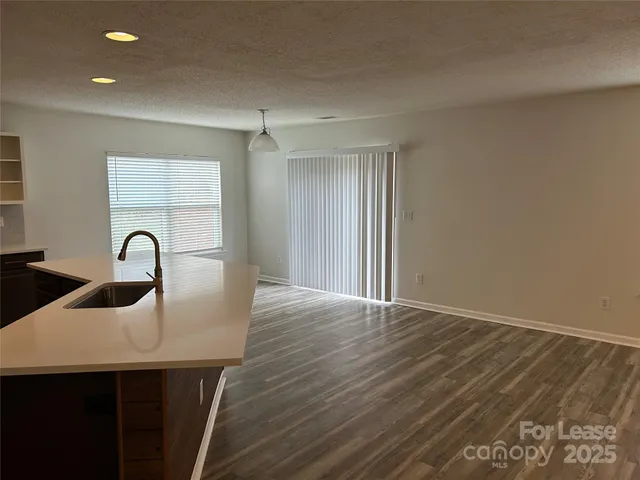 a view of kitchen and dining room with wooden floor