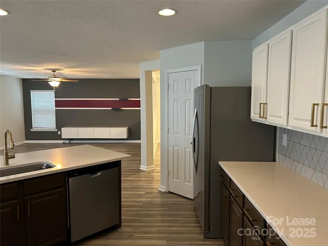 a kitchen with a sink and a refrigerator