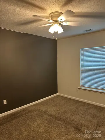 a view of a livingroom with a chandelier fan
