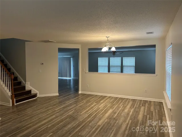 wooden floor in an empty room with stairs