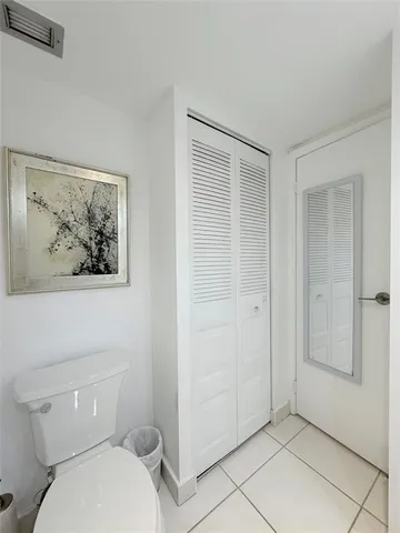 a white toilet sitting next to a bathroom sink