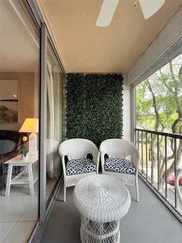 a bedroom with furniture and a large window