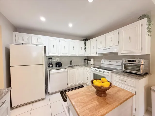 a kitchen with a refrigerator a stove a microwave and cabinets