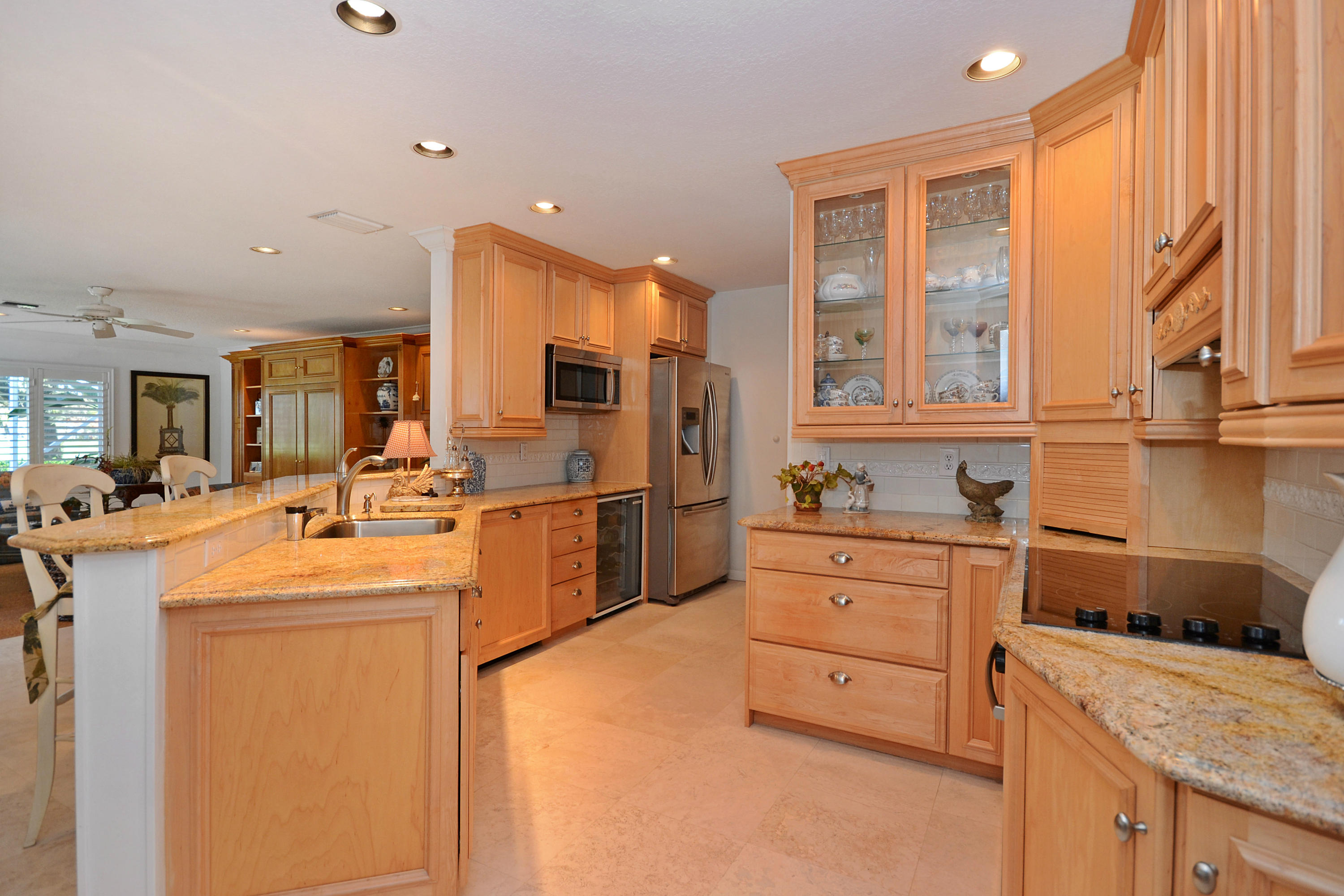 17301 Balboa Point Way Boca Raton, FL 33487 - Photo 4 of 10 a kitchen that has a lot of cabinets in it and wooden floors