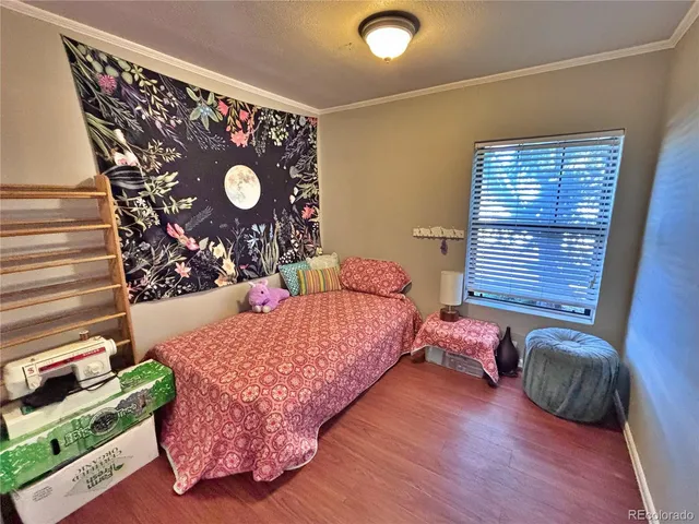 a bedroom with a bed window and wall painting