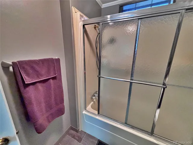 a bathroom with a glass shower door