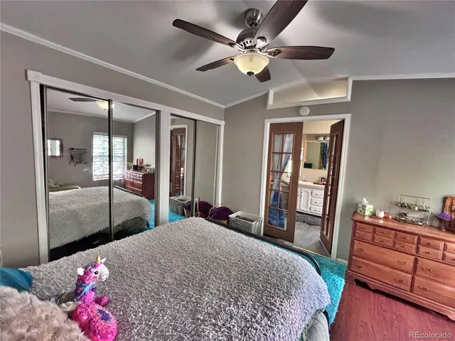 a bedroom with a bed dresser and a large mirror