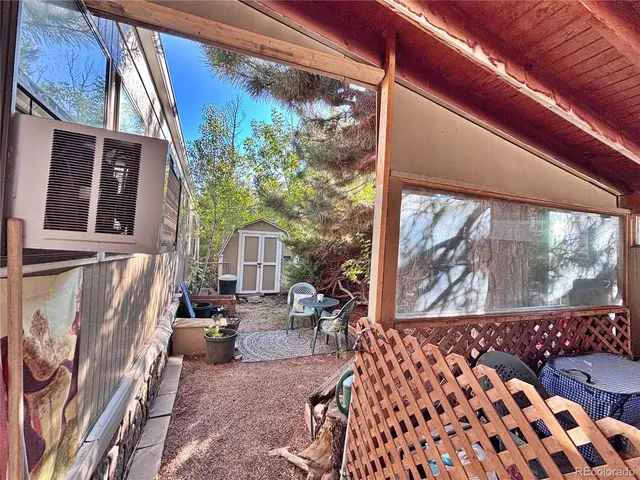 a view of a backyard with sitting area and garden