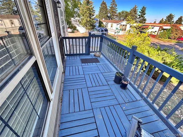 a view of balcony with wooden floor