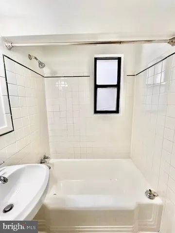 a bathroom with a bath tub and a shower