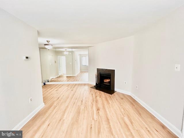 3819 Davis Place Northwest, Unit 1 Washington, DC 20007 - Photo 5 of 18 a view of empty room with wooden floor and fireplace