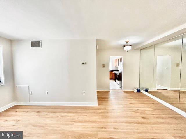 3819 Davis Place Northwest, Unit 1 Washington, DC 20007 - Photo 6 of 18 a view of a livingroom with wooden floor and kitchen space