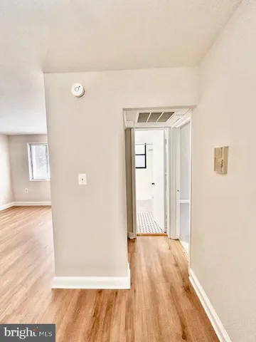 a view of a room with wooden floor