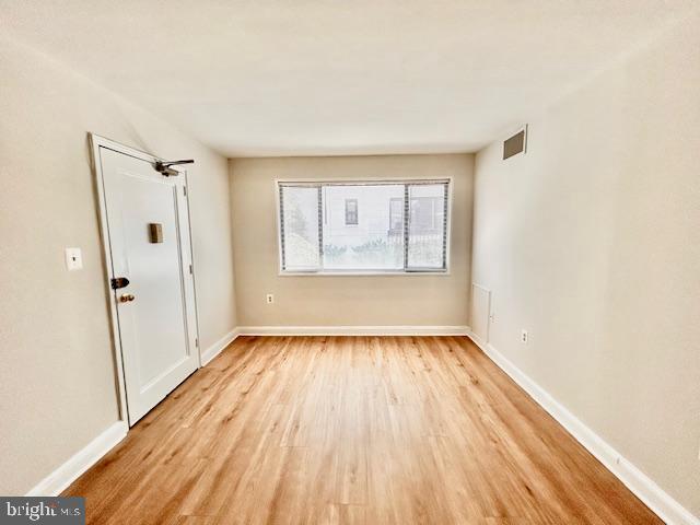 3819 Davis Place Northwest, Unit 1 Washington, DC 20007 - Photo 8 of 18 an empty room with wooden floor and windows
