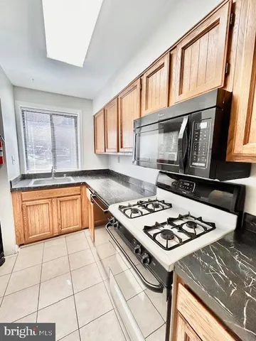 a kitchen with a stove a sink and a microwave