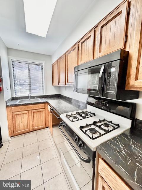 3819 Davis Place Northwest, Unit 1 Washington, DC 20007 - Photo 9 of 18 a kitchen with a stove a sink and a microwave