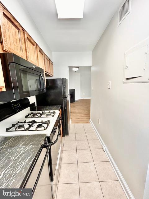 3819 Davis Place Northwest, Unit 1 Washington, DC 20007 - Photo 10 of 18 a kitchen with a stove a refrigerator and a microwave